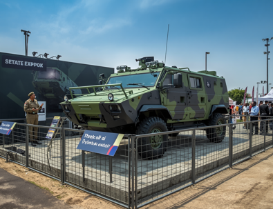 Tactical Vehicle Displayed On Platform With Barriers